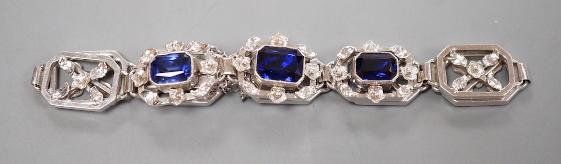 A modern 9ct white metal and three stone emerald cut sapphire set pierced link bracelet, approx. 18cm, gross weight 16.7 grams.